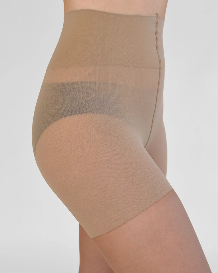 Beige shapewear tights worn by a person on a plain background
