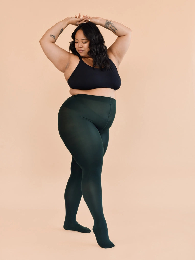Woman wearing a black  bra and green leggings 