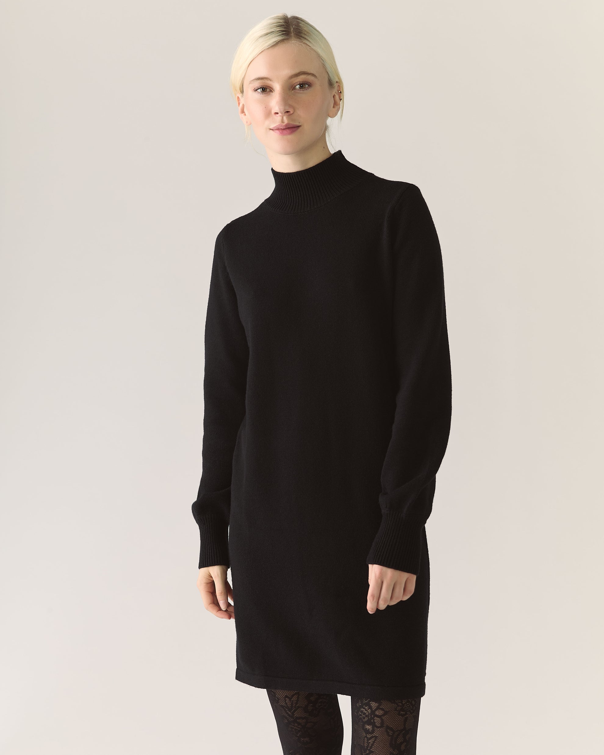 Woman wearing a black turtleneck sweater dress