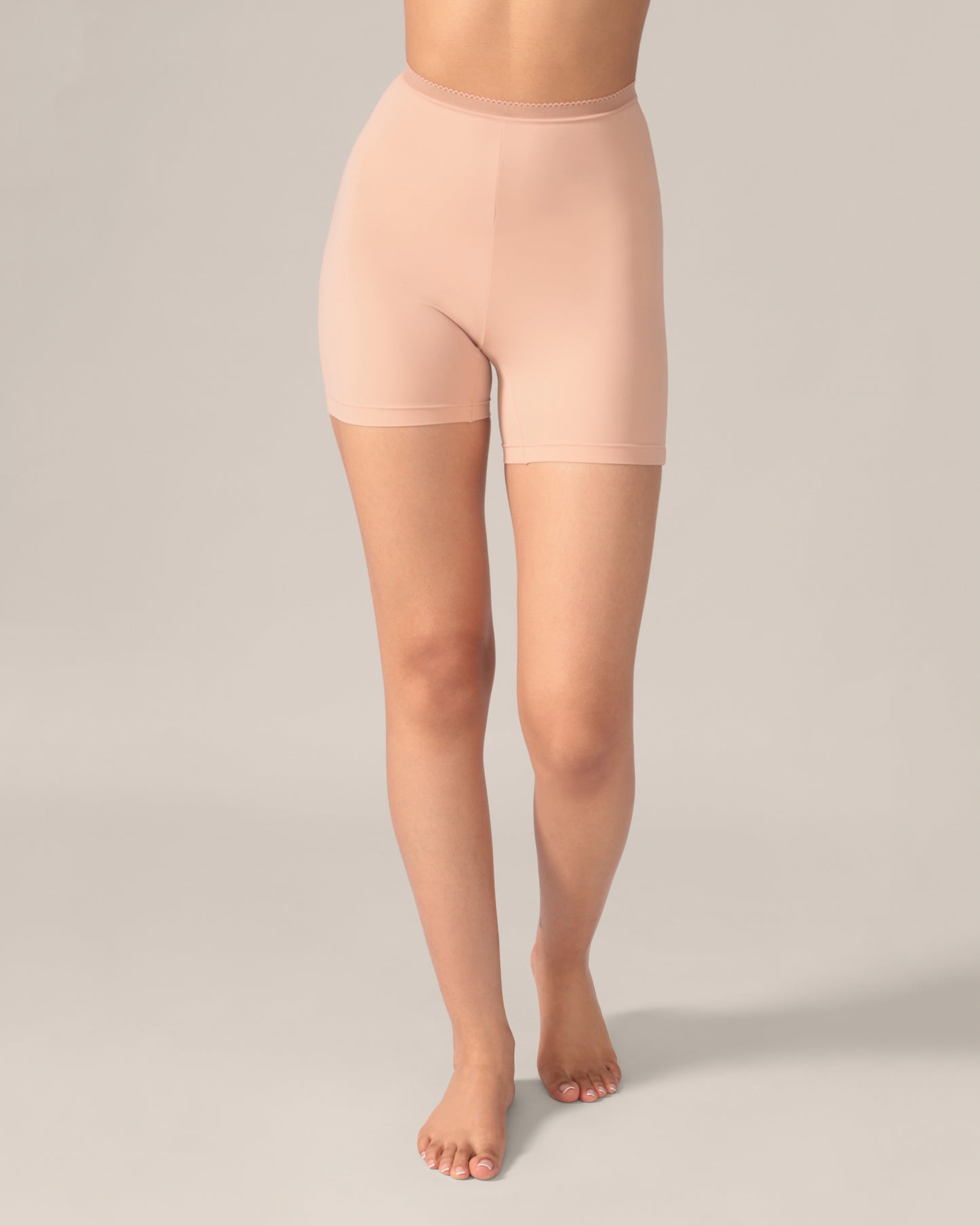 Beige shapewear shorts worn by a person on a neutral background