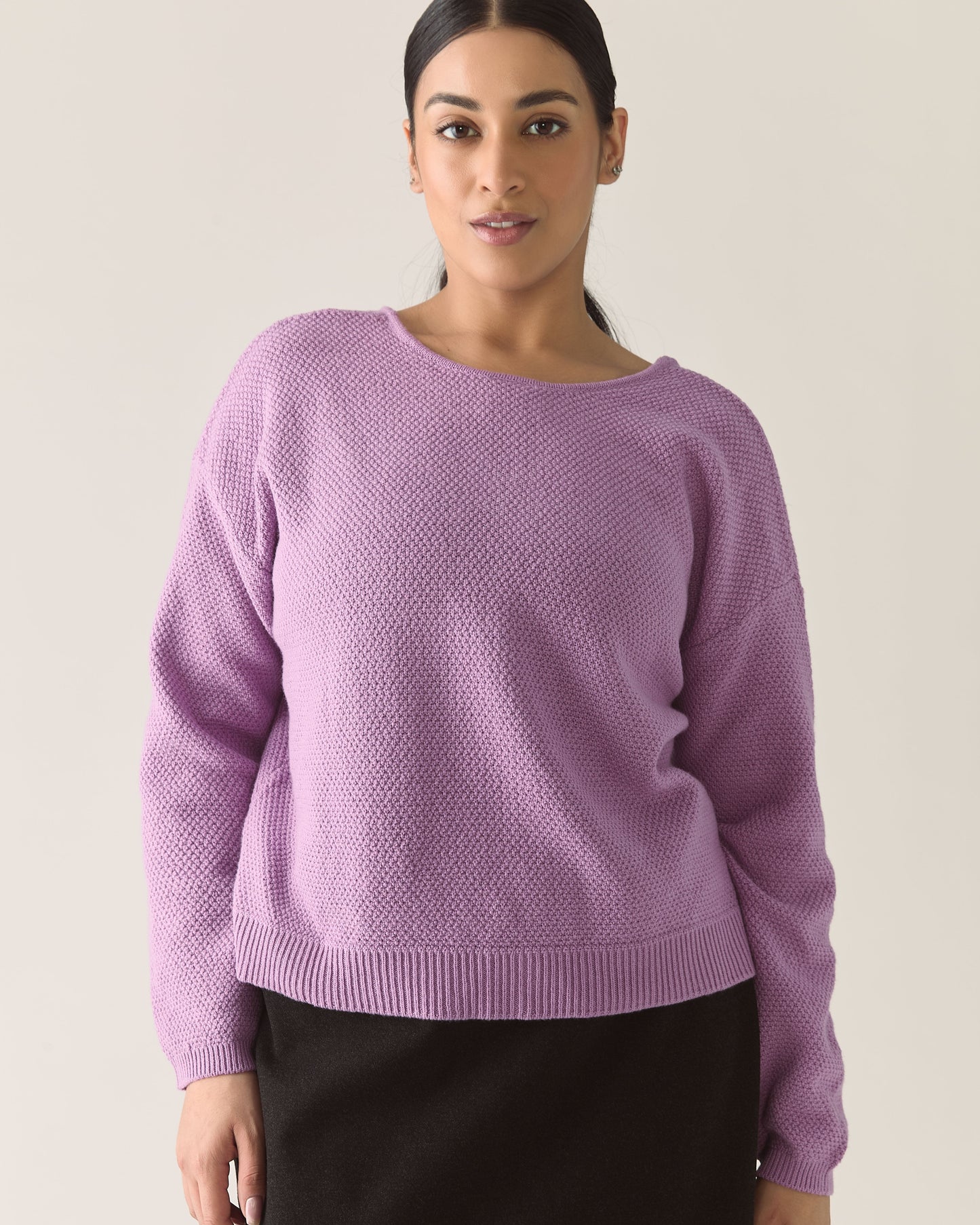 Woman wearing a lilac purple cardigan sweater