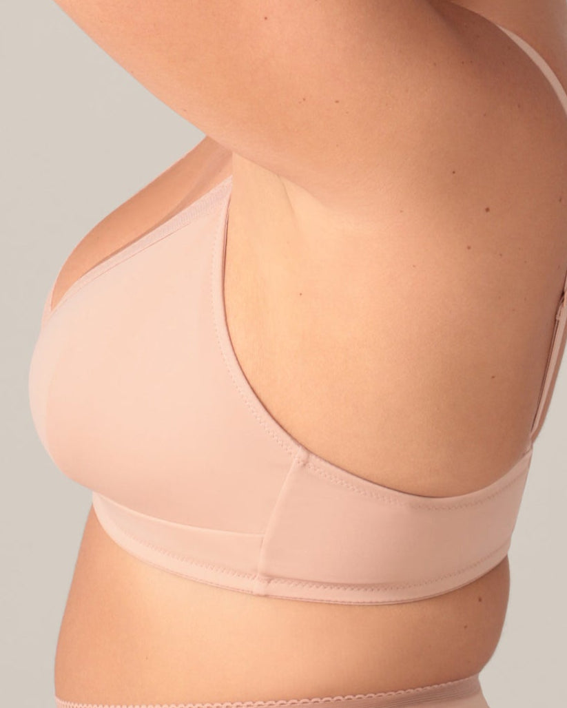 Beige bra worn by a person on a neutral background