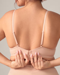 Beige bra worn by a person with a neutral background